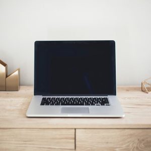 MacBook Pro on top of brown table